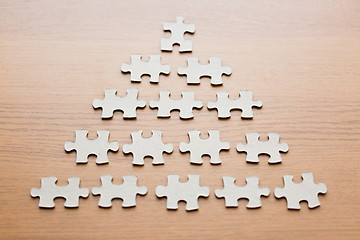 Image showing close up of puzzle pieces on wooden surface