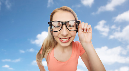 Image showing happy young woman or teenage girl in eyeglasses