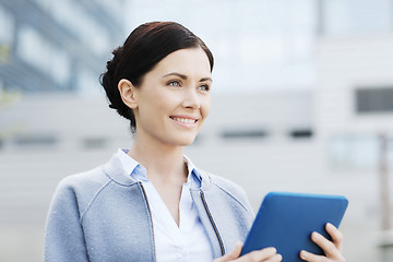 Image showing smiling business woman with tablet pc in city