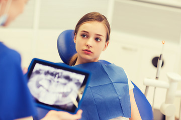 Image showing dentist with x-ray on tablet pc and girl patient