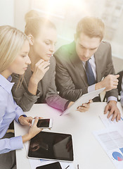 Image showing business team with tablet pc having discussion