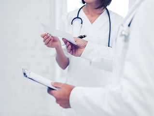 Image showing two doctors writing prescription