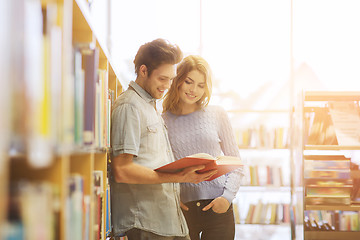 Image showing happy student couple with books in library