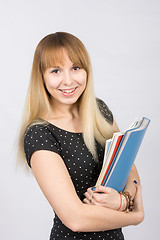 Image showing Happy young girl with a folder in his hands happily smiling in the picture