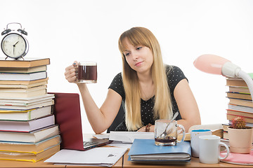 Image showing The student prepares a thesis project at night and drank another cup of coffee