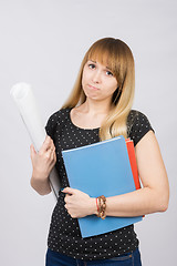 Image showing Young girl student with a project in hand and angrily looks into the frame