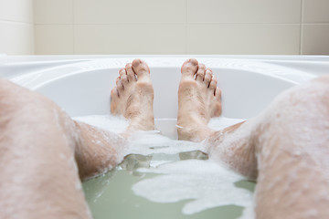 Image showing Men\'s feet in a bathtub, selective focus on toes