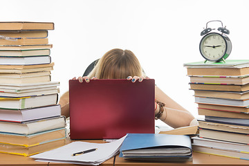 Image showing Student in despair laid her head on laptop