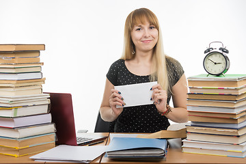 Image showing She has prepared an envelope with a bribe teachers for successfully completing the exam