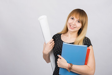 Image showing Girl student smiling and holding blueprints and a folder with documents