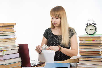 Image showing The teacher said the amount of bribe in an envelope