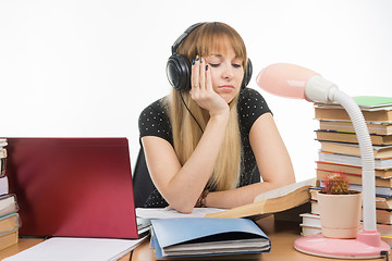 Image showing Student falling asleep reading a reference book