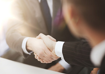 Image showing two businessmen shaking hands in office