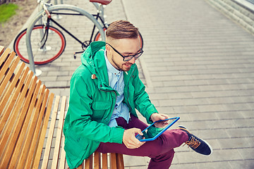 Image showing happy young hipster man with tablet pc and bike