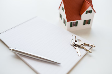 Image showing close up of home model, house keys and notebook