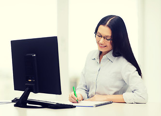 Image showing smiling businesswoman or student with eyeglasses