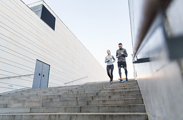 Image showing couple running downstairs on city stairs