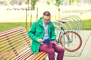 Image showing happy young hipster man with tablet pc and bike