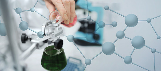 Image showing close up of scientist filling test tubes in lab