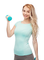 Image showing smiling beautiful young sporty woman with dumbbell