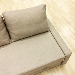 Image showing Elegant sofa-bed on wooden floor