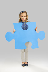 Image showing Girl holding a puzzle