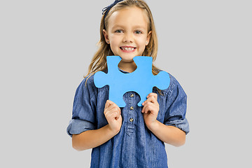 Image showing Girl holding a puzzle