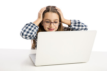 Image showing Little girl working with a laptop