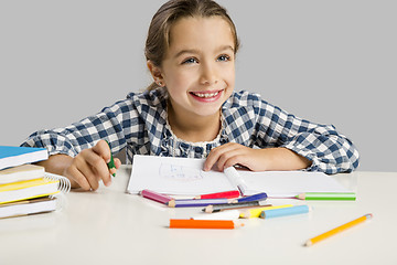 Image showing Little girl making drawings