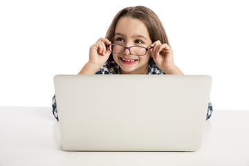 Image showing Little girl working with a laptop