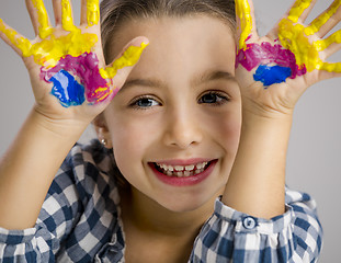 Image showing Little girl with hands in paint