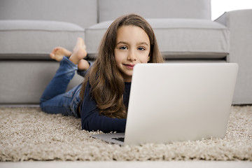 Image showing Little girl working with a laptop