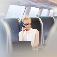 Image showing Business woman working while travelling by train.