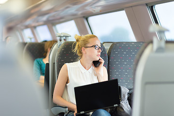 Image showing Business woman working while travelling by train.