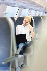 Image showing Woman sleeping while travelling by train.