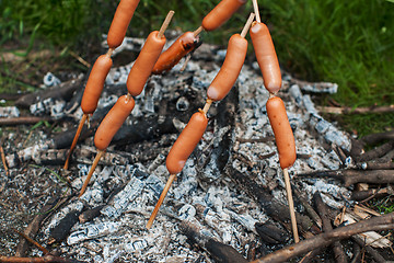 Image showing grilled sausages on camp fire