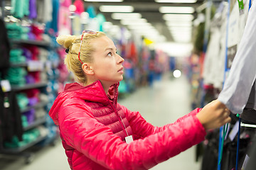 Image showing Woman shopping sportswear in sports store.