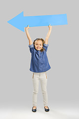 Image showing Girl holding a big blue arrow