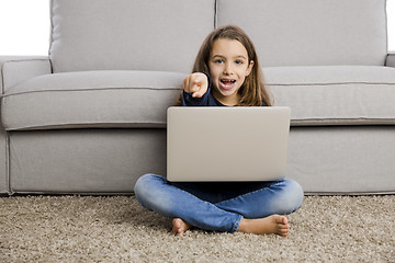 Image showing Little girl working with a laptop