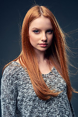 Image showing Beautiful red haired female in grey sweater