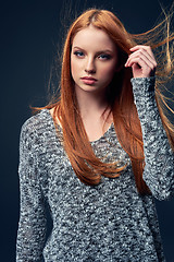 Image showing Beautiful red haired female in grey sweater