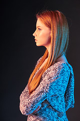 Image showing Side view portrait of red haired girl looking forward