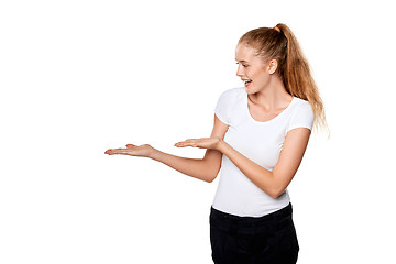 Image showing Smiling woman showing open hand palm with copy space