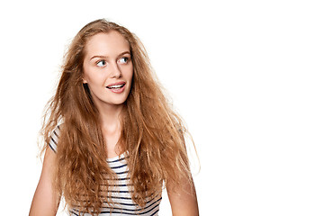 Image showing Excited teen girl looking to the side in amazement.