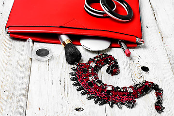 Image showing Red clutch bag and ladies accessories