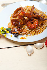 Image showing Italian seafood spaghetti pasta on red tomato sauce 