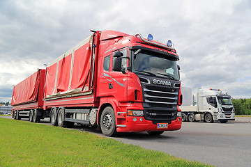 Image showing Red Scania, Green Grass, Grey Sky