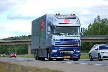 Image showing DAF XF Flower Truck Moves along motorway among traffic