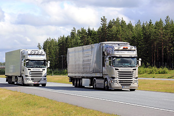 Image showing Scania R490 Cargo Truck Overtakes another Truck on Motorway
