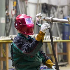 Image showing Industrial worker welding in metal factory.